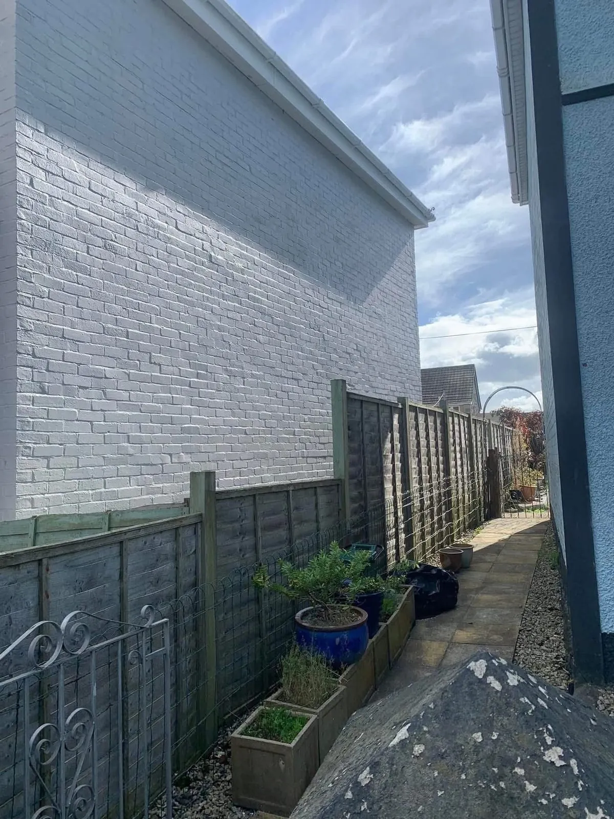 Freshly painted brick wall after preparation and masonry paint in Torpoint